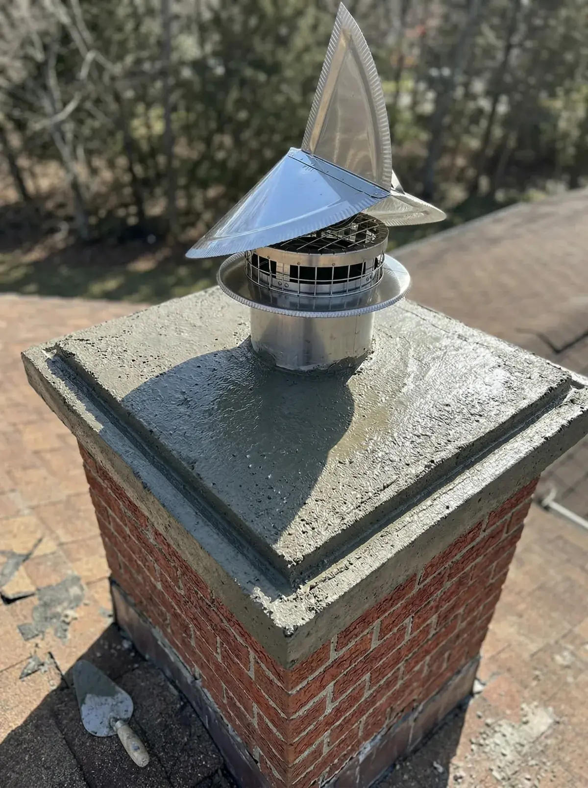 Newly poured concrete chimney crown with proper drip edge and overhang